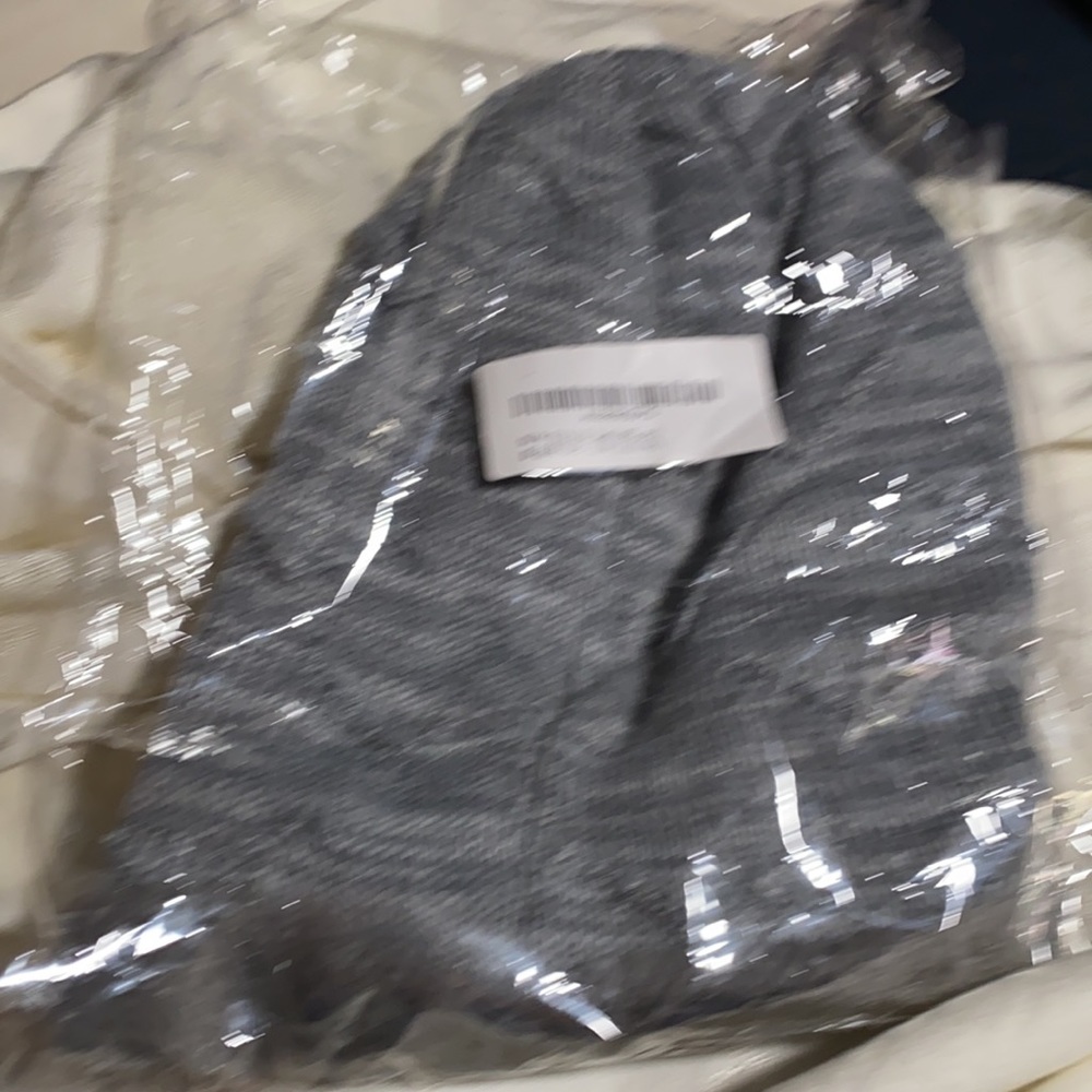 Brand new gray fuzzy winter hat that is knitted
